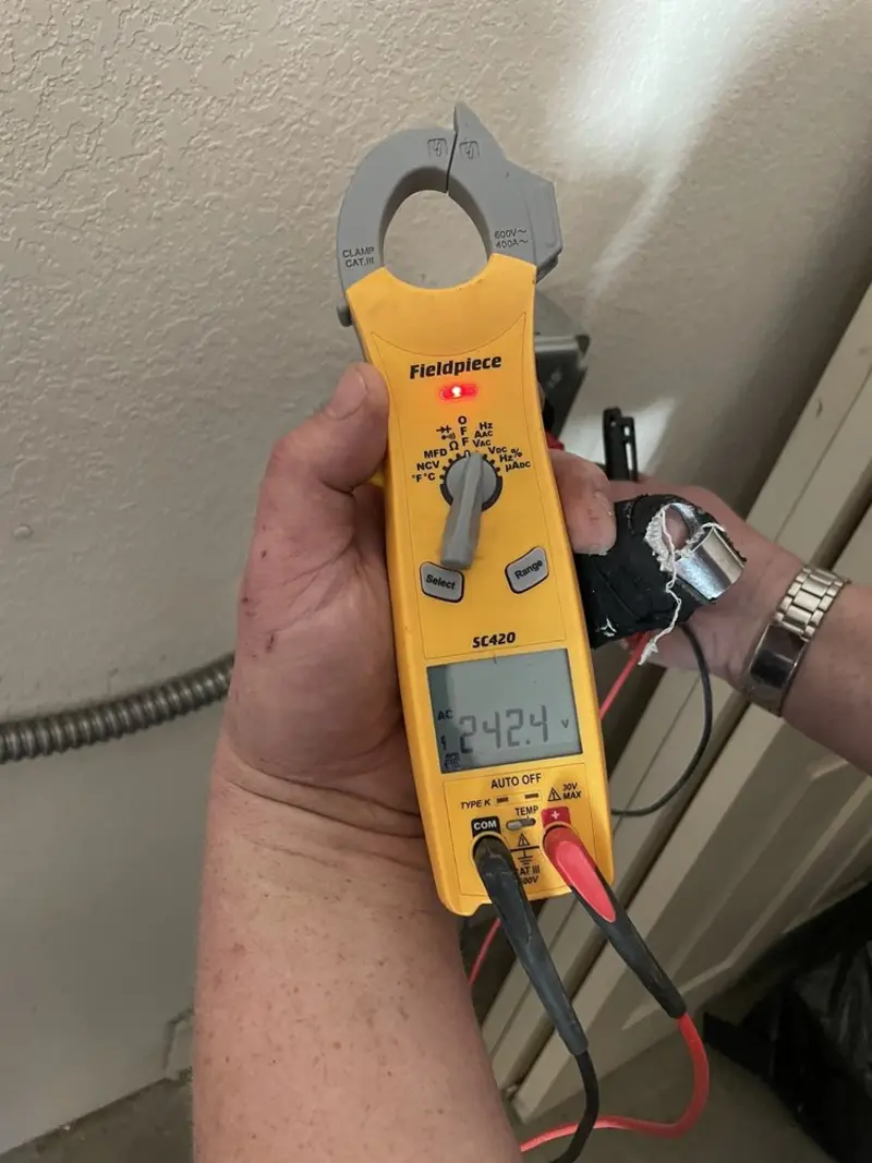 Voltage testing with clamp meter during Outlet Installation in International Falls